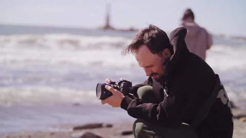 The guy is filming the sea on camera. Stock Footage 316831170
