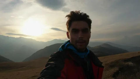 The guy films himself against the background of mountains Stock Footage 171992640