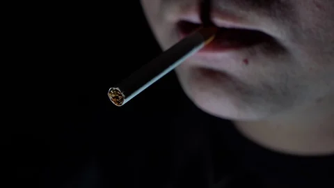 The guy fire on a cigarette on a dark background. Stock Footage 129182328