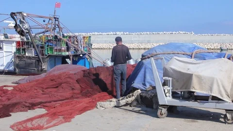 Guy fixing fishing nets Stock Footage 122736967