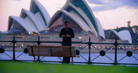 Guy Fixing His Camera With Sydney Opera House In The Background In NSW, Video stock 170360534