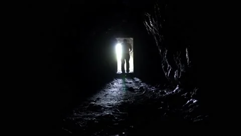 The guy with the flashlight comes out of the cave Video stock 208139781