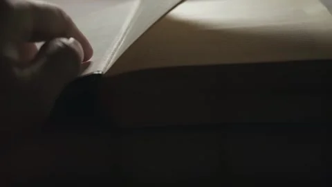 The guy is flipping through an old book quickly, slow motion Stock Footage 264874336