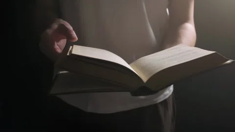 A guy is flipping through an old book, a man is reading a book Stock Footage 264874891
