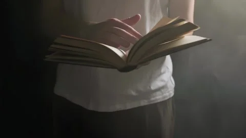 A guy is flipping through an old book, a man is reading a book Stock Footage 266449591