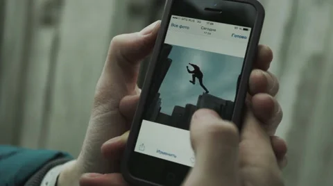 The guy flips through photos on the phone Stock Footage 60066447