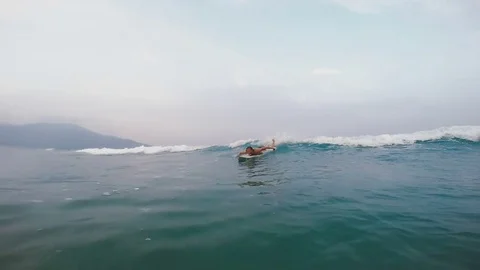 Guy is floating on the board on the wave Stock Footage 80535709