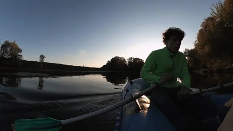 A guy is floating on an inflatable boat on the river, a man is in a boat Stock Footage 210041459