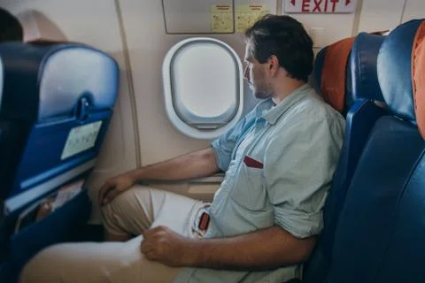 The guy is flying in an airplane. Stock Photos
