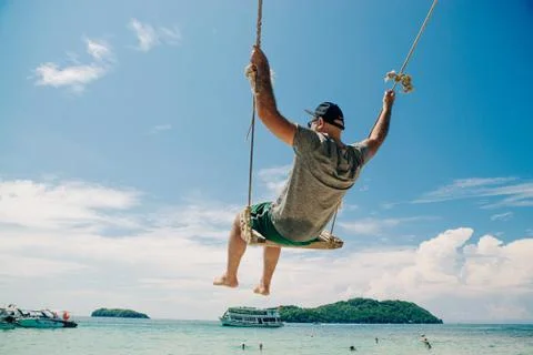 Guy flying on a swing Stock Photos