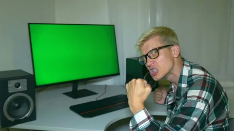 Guy is fooling around and threatening with his fist at the screen. Stock Footage 204946297