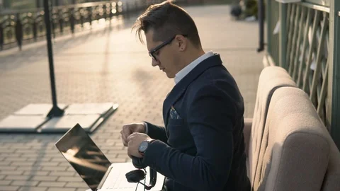 Guy in formal suit posing with headphones outdoor. Eyes closed Stock Footage 87246663