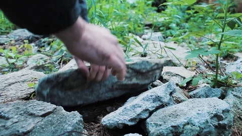 The guy found the phone among the rocks Stock Footage 113859328