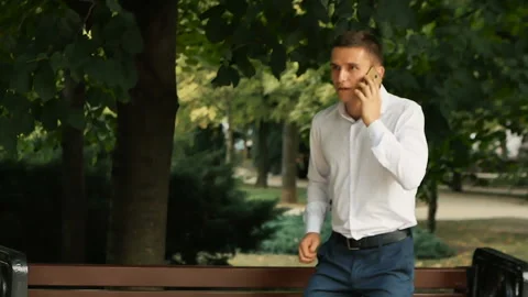 Guy found a smartphone in the Park Video stock 104473493