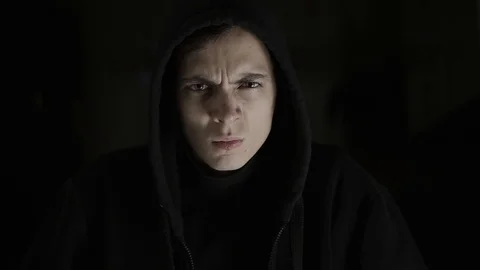 A guy full of energy, anger, rage and strength, with a sweatshirt and a hood Stock Footage 120597553