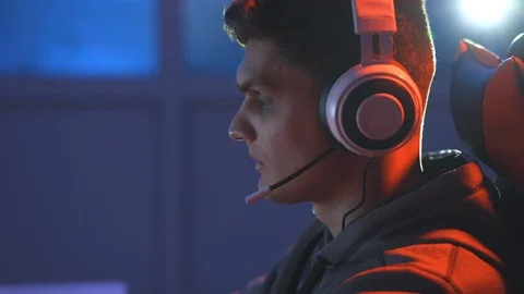 The guy gamer with headset playing video games online Stock Footage 127271828