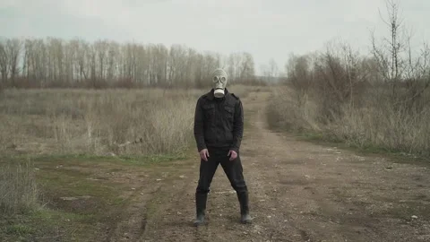 The guy in the gas mask in the background is dancing the dance of UNO Stock Footage 130428076