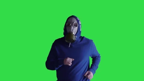 A guy in a gas mask while jogging against a green background Stock Footage 127536800