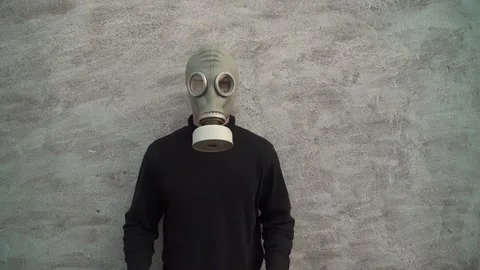 The guy in the gas mask. on a white background. picks up the stop sign covid 19 Stock Footage 130523520