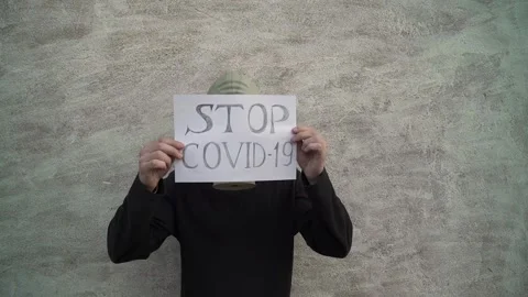 The guy in the gas mask. on a white background. puts a stop sign covid 19. Stock Footage 130523853