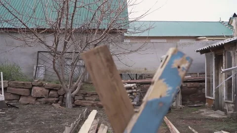 Guy in the gasmask is gaining the wood to be cut. view across the Board 動画素材 130523702
