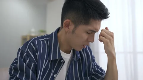 Guy gentling tapping head with painful expression Video stock 153067745