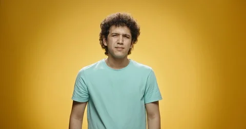 Guy gesturing no. Young asian man with curly hair in casual clothing looking at Видео 117370868