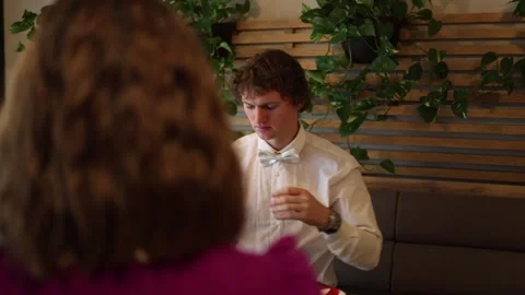 Guy gets message from another girl on date Stock Footage 328285091