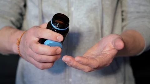 The guy gets out of the banks of the capsule, medicine, medication. closeup Video stock 128450585