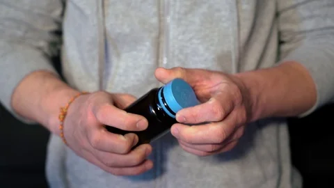 The guy gets out of the banks of the capsule, medicine, medication. closeup. Video stock 128451067