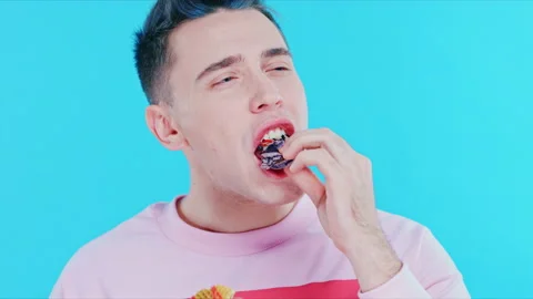 The guy gets pleasure from sweet. The boy is trying the dessert Stock Footage 89628942