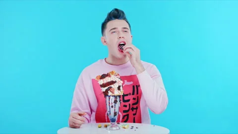 The guy gets pleasure from tasting sweet Stock Footage 89729885