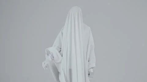 Guy in a ghost costume with a white sheet throws out a cardboard sign that reads Stock Footage 287915465