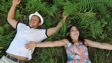 The guy with the Girl Lay down in the Grass. Summer Stock Footage 68084930