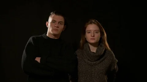 The guy with the girl stand on a black background 库存影片 72285155