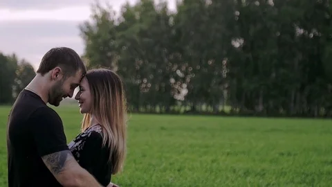 Guy with the girl stand close to each other and smiling Stock Footage 79605650