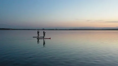Guy with girl on the sunset float on the SAP Board Stock Footage 130558822
