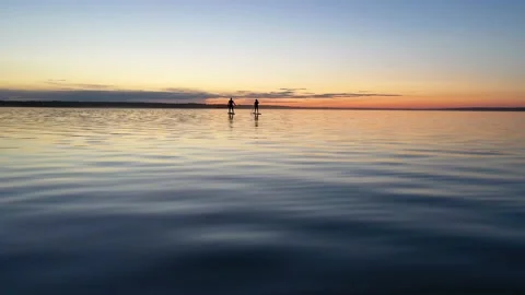 Guy with girl on the sunset float on the SAP Board Stock Footage 130559477