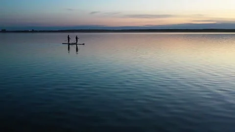 Guy with girl on the sunset float on the SAP Board Stock Footage 130559492