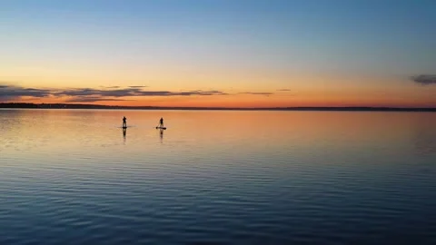 Guy with girl on the sunset float on the SAP Board Stock Footage 130559674