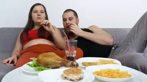 A guy with a girlfriend watching TV and it comes to a cat. Stock Footage 122820522