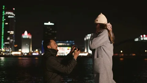 Guy gives a ring to his girlfriend Stock Footage 128917049