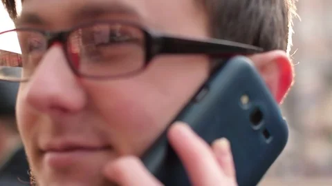 Guy with glasses having fun talking on the phone Video stock 83518275