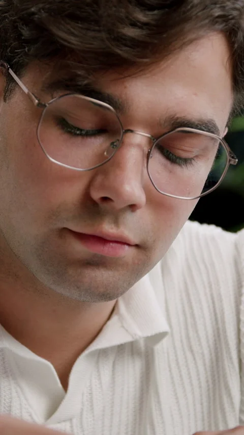 Guy in glasses studies intently writing notes with pencil Stock Footage 313926569