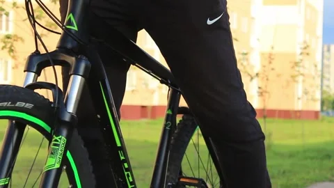 The guy goes to the bike. Evening time. Brightly dressed Stock Footage 130740736