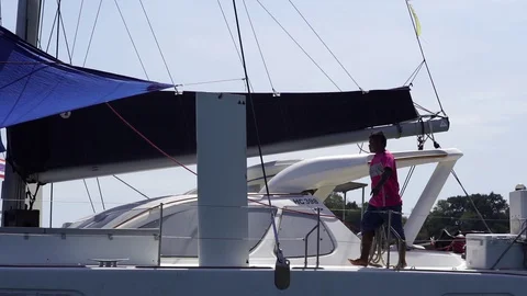 Guy goes on the deck of a motor yacht Stock Footage 129042895
