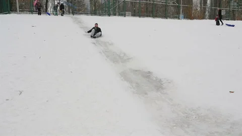 Guy goes down the snow-covered hill. Slow motion 01.10.2020 Ukraine, Kiev Stock Footage 126341236