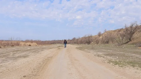 Guy goes forward, walk on empty terrain Stock-Footage 128450816