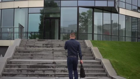 The guy goes up the stairs before working day. Stock Footage 113557910