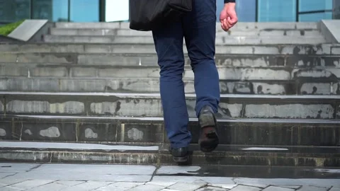 The guy goes up the stairs before working day. Close up view Stock Footage 113559253